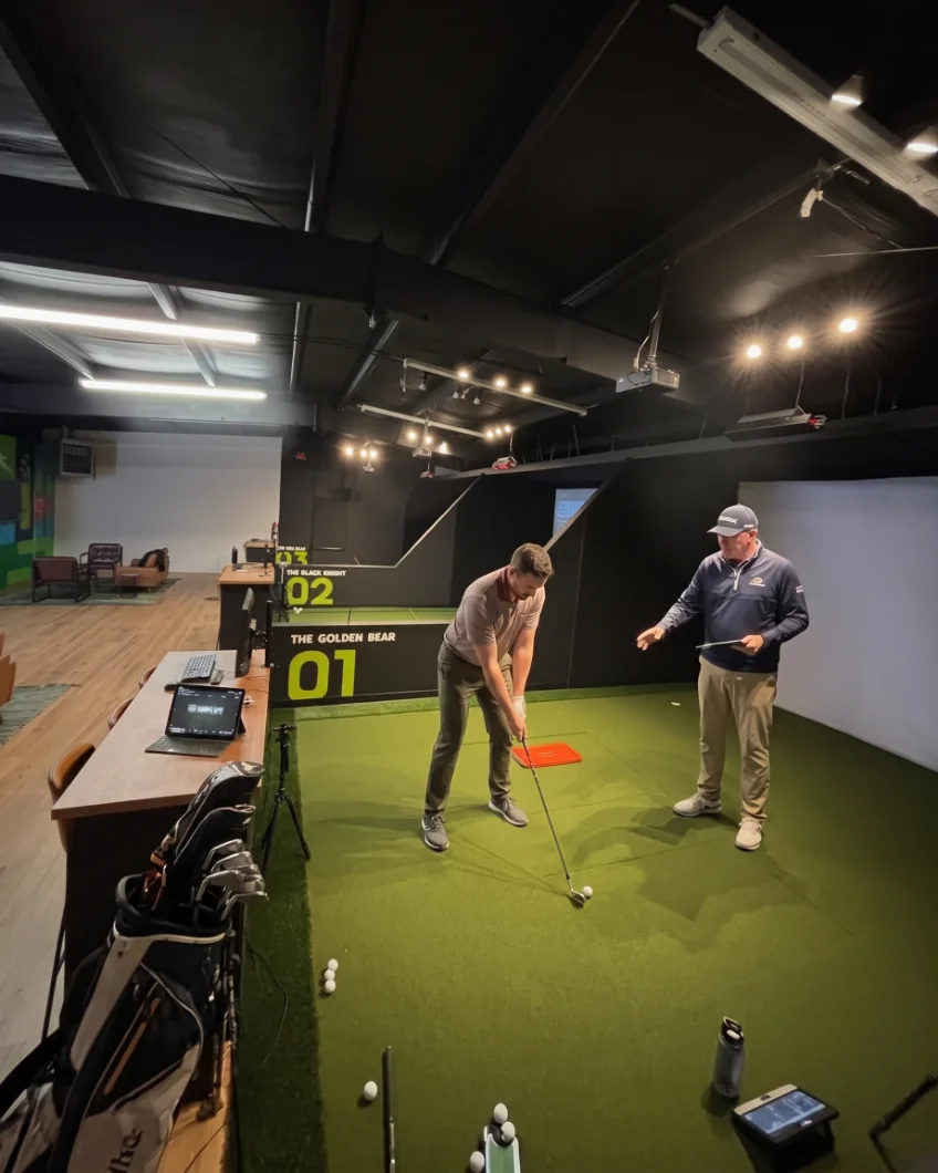 Golf lesson with a coach in a simulator bay near Liberty, MO